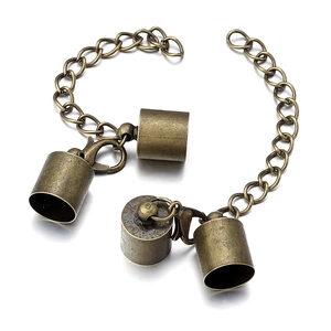 Macro detail of antique bronze lobster clasp set with cylinder end caps and chain