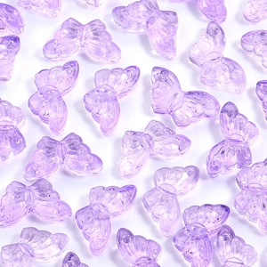 Macro detail of transparent purple butterfly charms with fine texture for DIY crafts