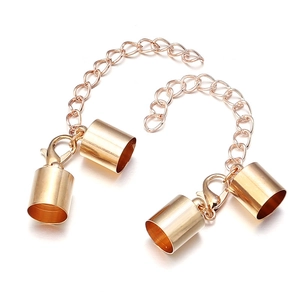 Detail of lobster claw clasp with extension chain and cylinder cord ends in rose gold
