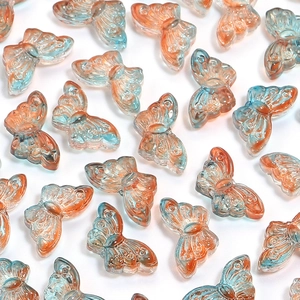 Detailed view of 50pcs transparent blue and orange gradient butterfly charms for DIY