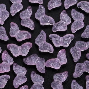 Detail of pink transparent butterfly beads with embossed wings for DIY jewelry