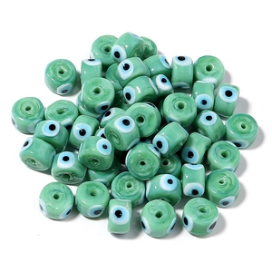 Light green glass evil eye beads in flat round shape for DIY jewelry making