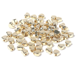 Macro shot of gold plated heart shaped CCB beads with side holes for DIY jewelry