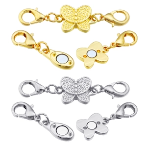 Detail of butterfly shaped magnetic jewelry clasps in gold and silver with lobster claws