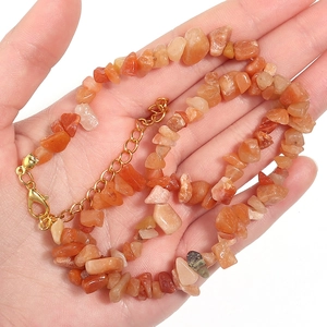 Detail of orange irregular agate stone beads necklace with gold lobster clasp