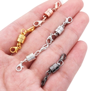 Magnetic lobster clasps for jewelry necklaces in four metallic colors held in hand