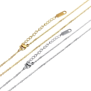 Detail of gold and silver stainless steel cross chains with lobster clasps and extension links