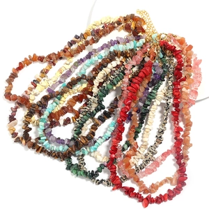 Close-up of irregular agate and crystal stone necklaces with adjustable gold clasps