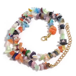 Detail of colorful irregular gemstone beads necklace with gold lobster clasp and extension chain