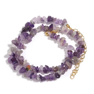 Detailed macro view of purple natural amethyst chip beads with a gold lobster clasp