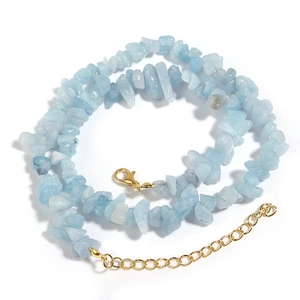 Detailed view of light blue irregular crystal stone necklace with golden lobster clasp