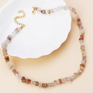 Macro shot of irregular natural stone necklace with golden lobster clasp and extender