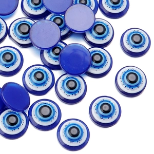 Macro detail of blue resin evil eye flatback charms for DIY jewelry making accessories