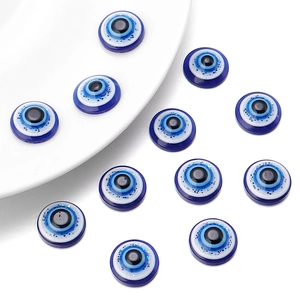 Detailed macro view of resin evil eye beads with blue glitter and polished finish
