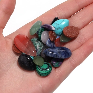 Polished teardrop and oval natural crystal agate gemstone cabochons held in palm
