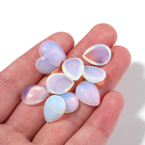 Handheld view of iridescent teardrop crystal cabochons for DIY jewelry making