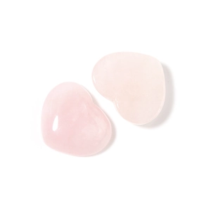 Close-up of heart-shaped pink rose quartz gemstones with polished reflective finish