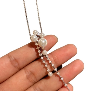 Elegant silver chain necklace with white pearls and tassel zircons in a long pendant style