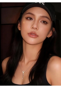 Close-up of elegant long zirconia tassel pearl pendant necklace on an Asian model