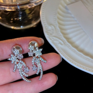 Detailed close-up view of sparkling star-shaped clip-on earrings with clear zircon stones