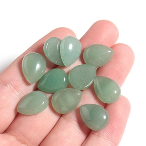 Close-up of teardrop-shaped natural green aventurine stones held in hand for DIY jewelry