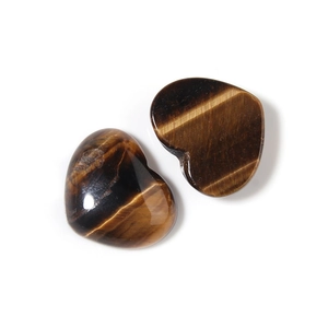 Macro detail of heart-shaped tiger eye stone cabochons with polished wood-like texture