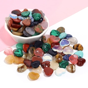 Assorted heart shaped crystal gemstones in a bowl for DIY jewelry making and decoration