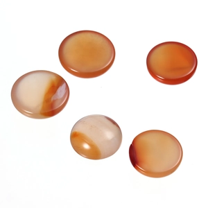 Close-up of five polished round red agate stone cabochons with natural white vein texture