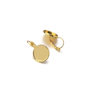 Close-up of golden leverback earring hooks with round trays for DIY jewelry making
