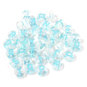 Flat lay of clear acrylic alphabet beads with sky blue letters for DIY bracelet making
