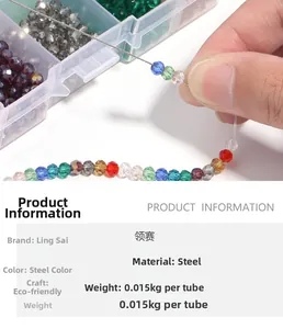 Detail of multi-colored faceted beads and steel beading needles for DIY jewelry making
