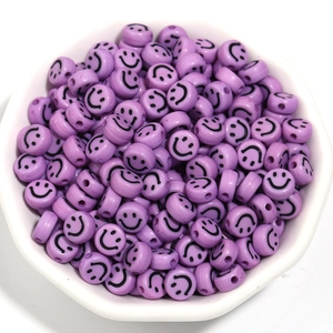 Bulk 7mm purple acrylic smiley face beads in a white bowl for DIY bracelet jewelry