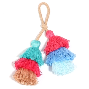Close-up of three-layer colorful cotton tassel keychain for bag decoration DIY accessory