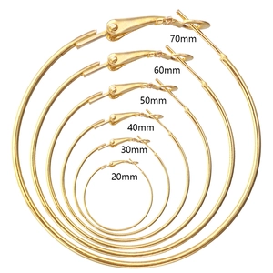 Set of six gold hoop earrings ranging from 20mm to 70mm diameter on white background