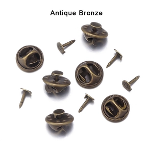 Dettaglio macro di chiusure a farfalla in bronzo antico e perni per badge fai-da-te