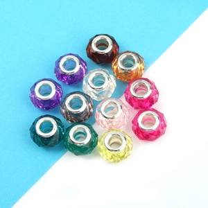 Macro shot of 12 colorful faceted resin beads with silver cores for DIY jewelry making