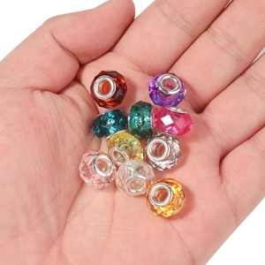 Faceted resin large hole beads in vibrant colors held by hand for DIY jewelry making
