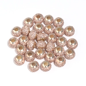 Macro shot of rose gold alloy Shamballa beads with pavé crystals for DIY jewelry