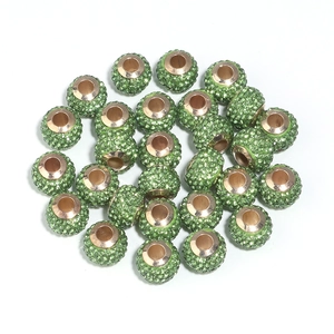 Macro shot of green rhinestone spacer beads for DIY jewelry with fine metal holes