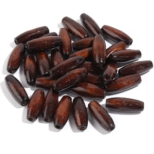 Macro shot of polished oval dark brown maple wood beads showing natural wood grain texture