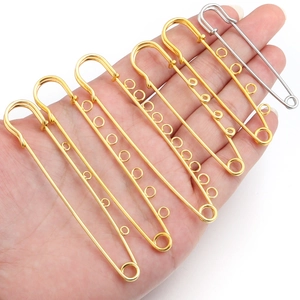 Detail of multi-hole gold and silver safety pins for DIY jewelry making