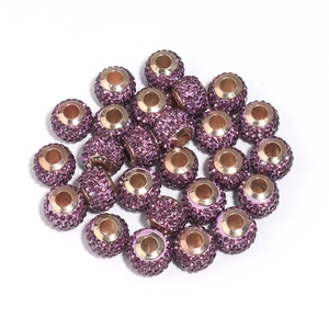 Close-up of purple pave crystal disco balls for DIY jewelry and handmade bracelets