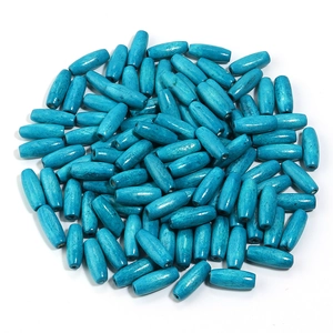 Macro shot of turquoise oval maple wood beads with natural texture for DIY jewelry making