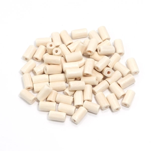 Macro detail of cylindrical maple wood beads with center holes for DIY jewelry making
