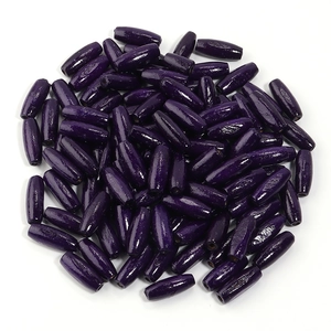 Close-up of polished purple oval maple wood beads for DIY jewelry making accessories