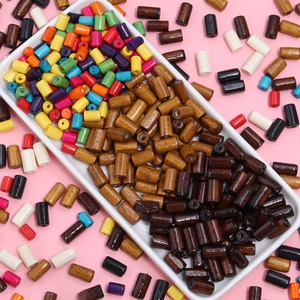 Colorful cylindrical maple wood beads for DIY jewelry making in a white tray display