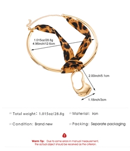 Detail view of leopard print ribbon choker necklace with irregular gold pendant and dimensions