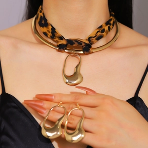Close-up of leopard print ribbon choker and matching irregular liquid gold earrings
