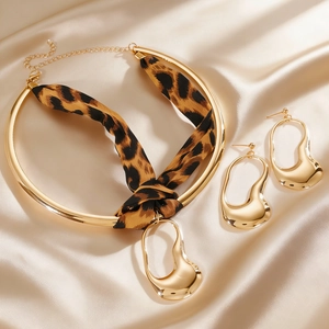 Detailed view of the leopard print ribbon choker and liquid-style irregular earrings set.