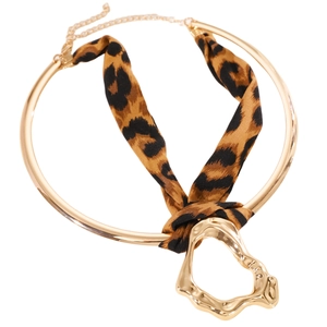 Close-up of leopard print ribbon choker with gold irregular liquid metal pendant